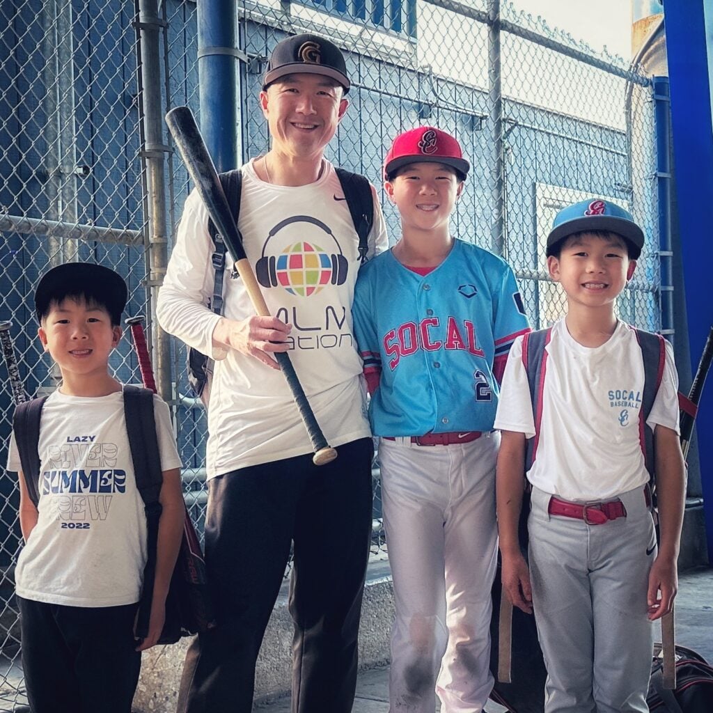 Simon Chan standing with his 3 boys