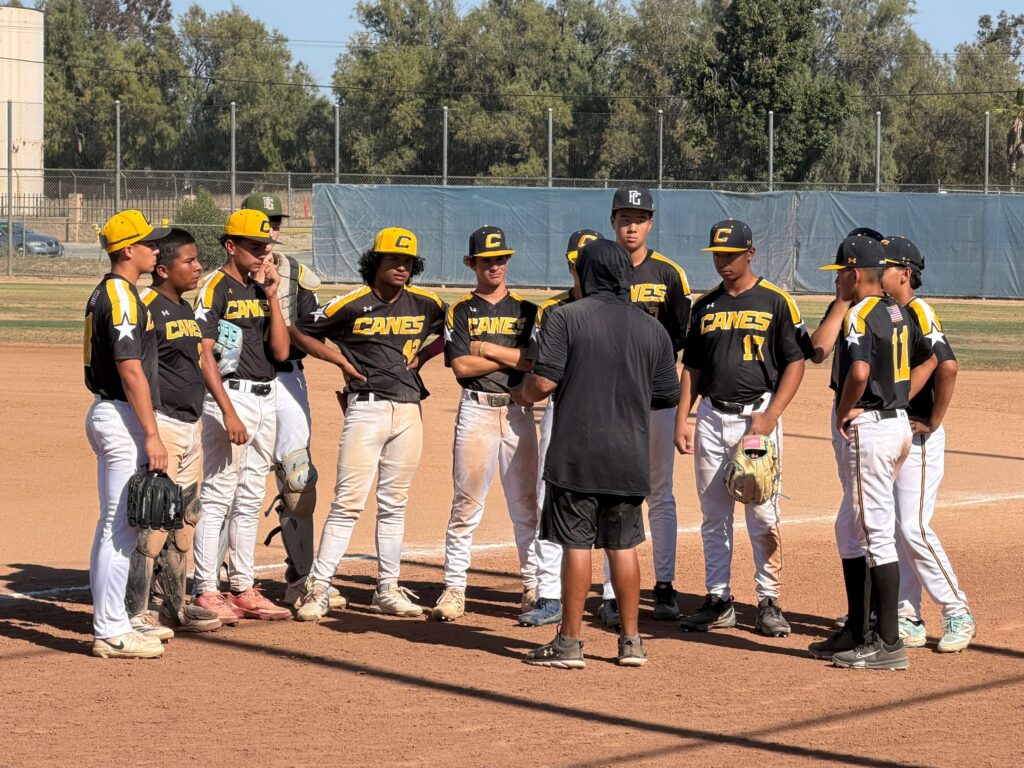 Canes Los Angeles team having a huddle on the field after a game