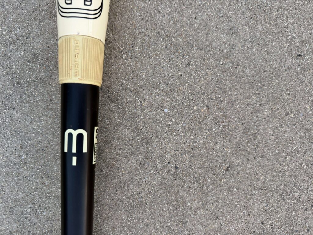 Warstic Bonesaber baseball bat handle displaying the minus 3 designation and BBCOR 50 certification stamp