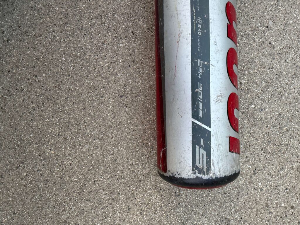 Close up of a used Marucci CATX baseball bat barrel showing the minus 5 size marking and 30 inch 25 ounce