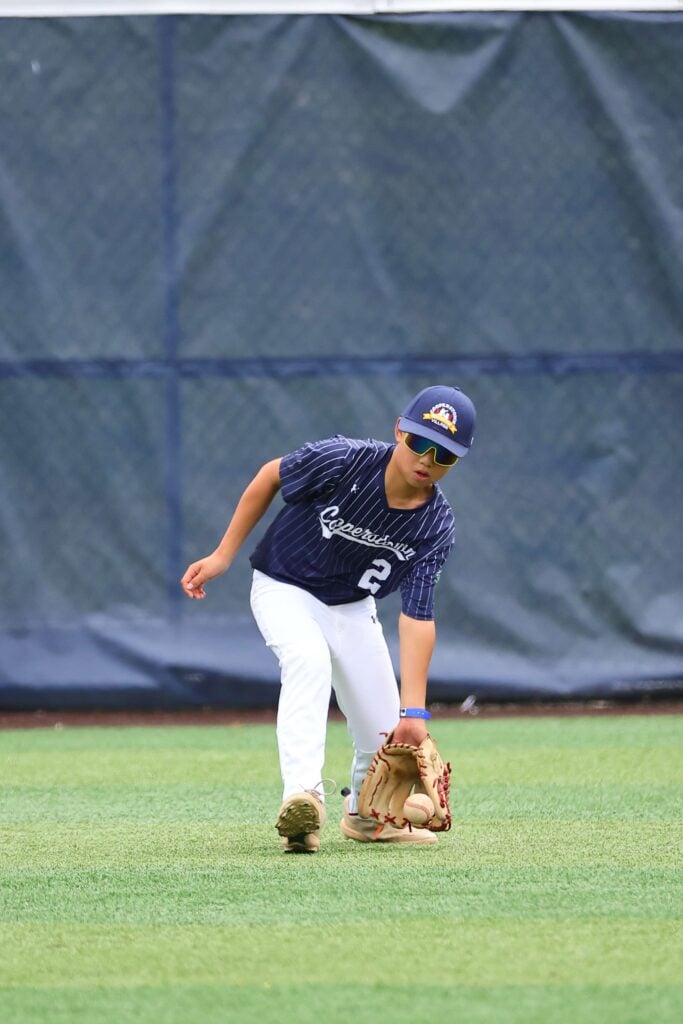 Brendan Chan fielding grounder in outfield