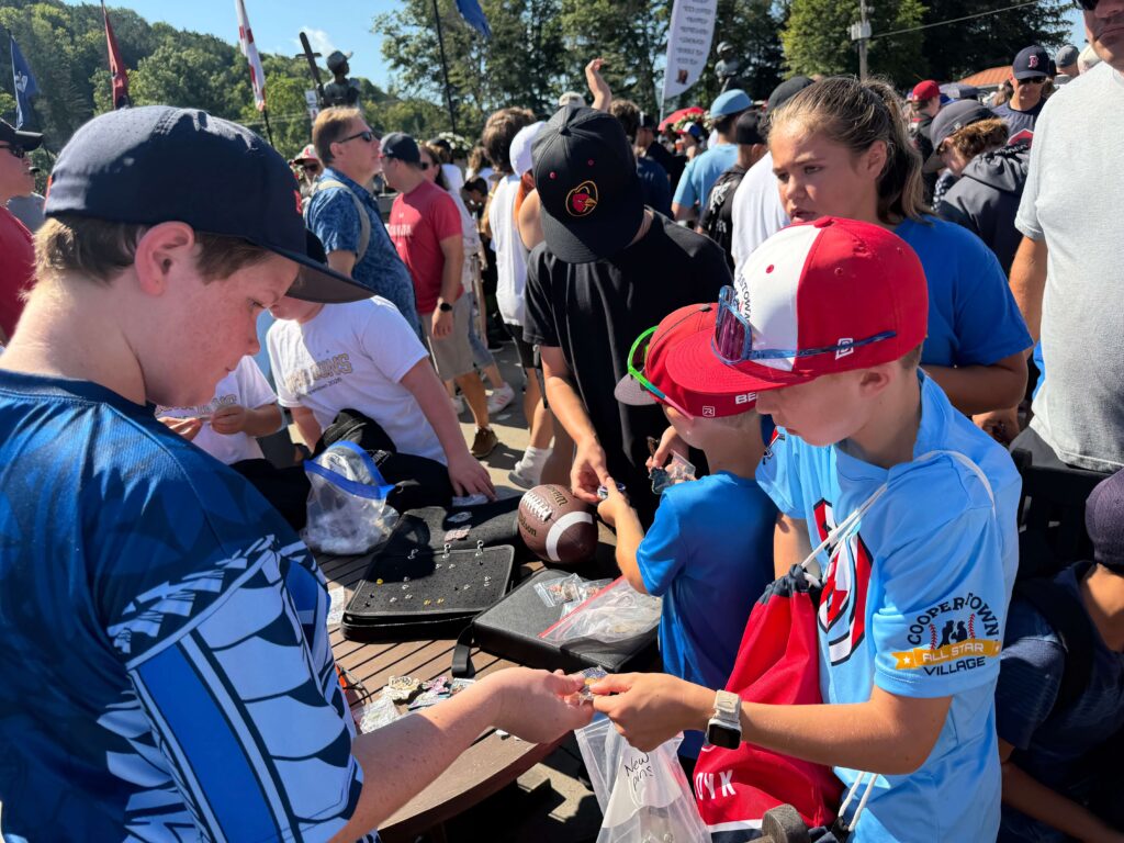 Kids trading a pin to another kid at All Star Village