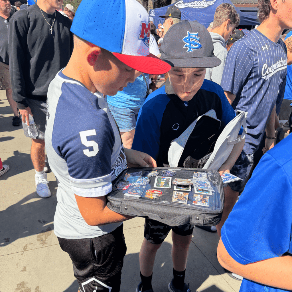 kid showing his pin collection at Cooperstown baseball tournament