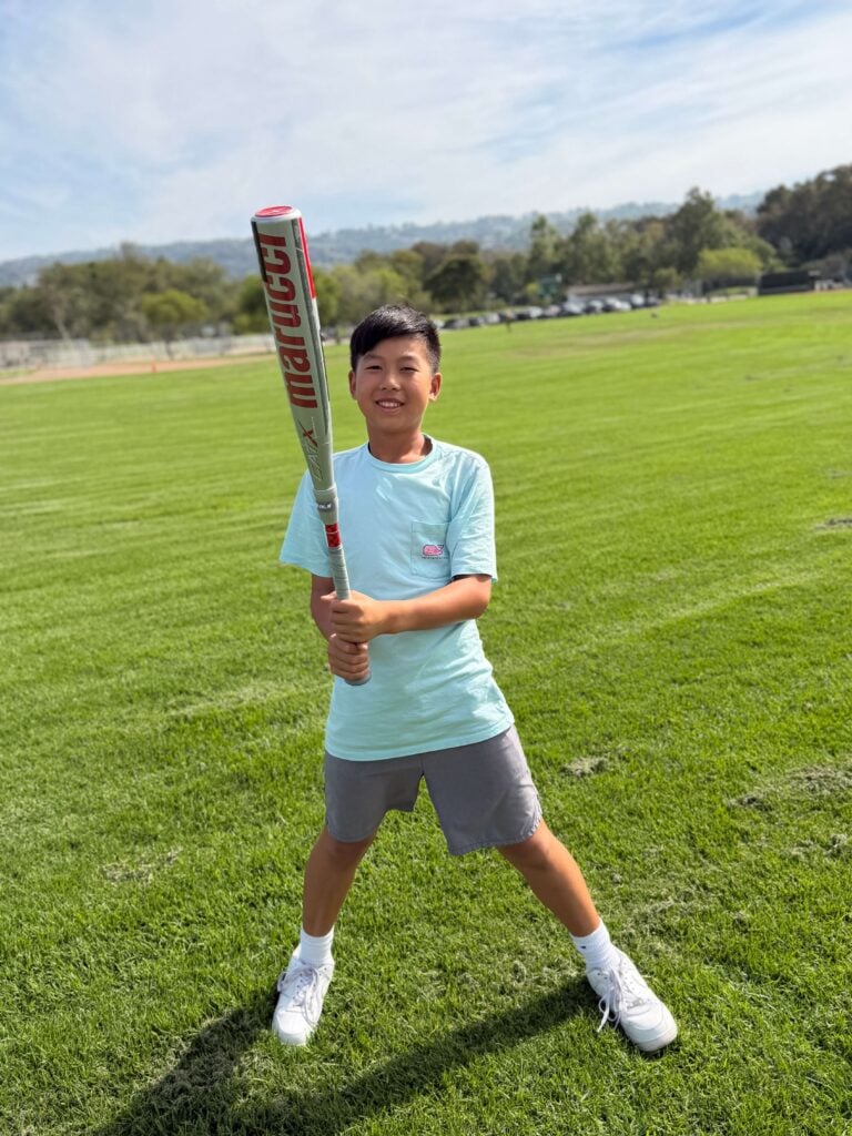 Son is smiling while holding a discounted Marucci CatX Composite