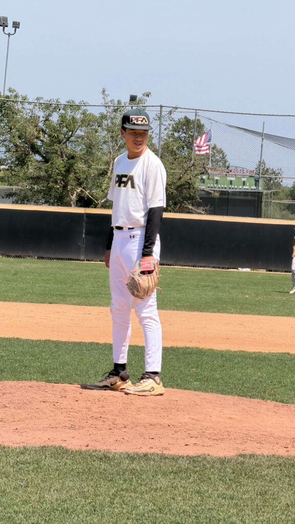 My oldest son smiling and relaxed on the pitching mound and demonstrating baseball mental toughness during a tight game in last inning