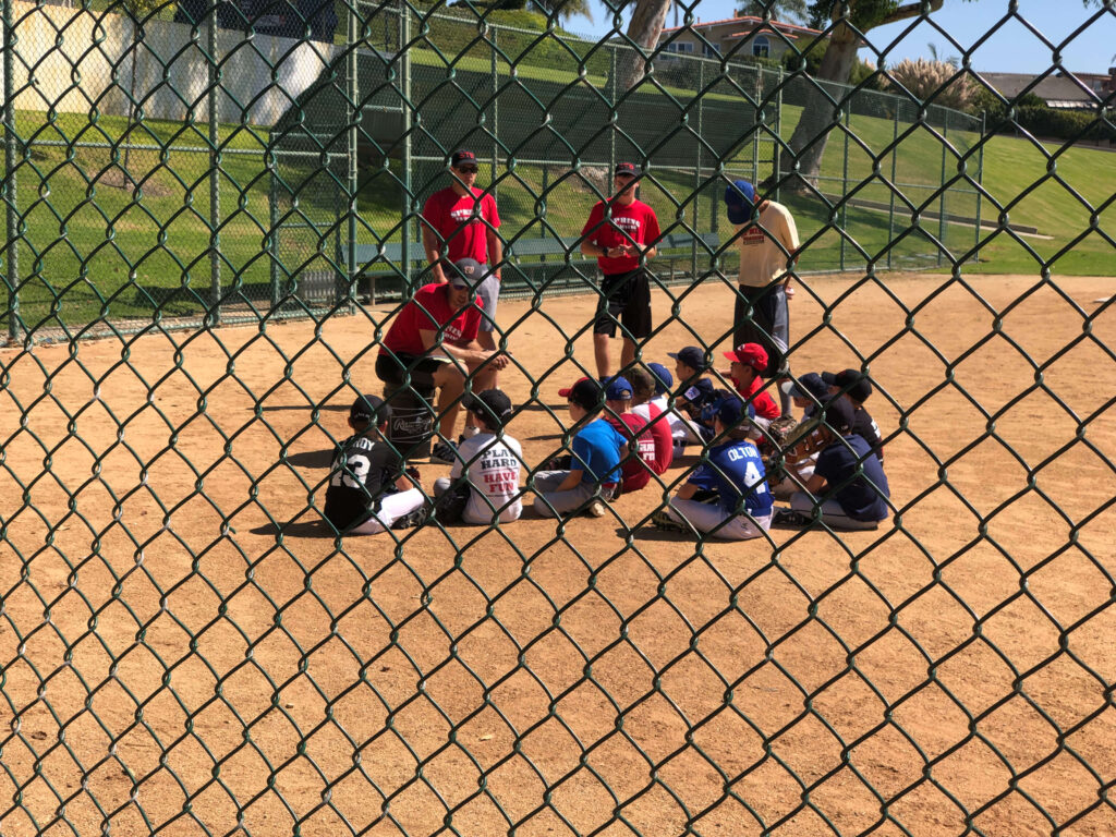 Dan and coaching staff doing practice huddle before fall baseball camp