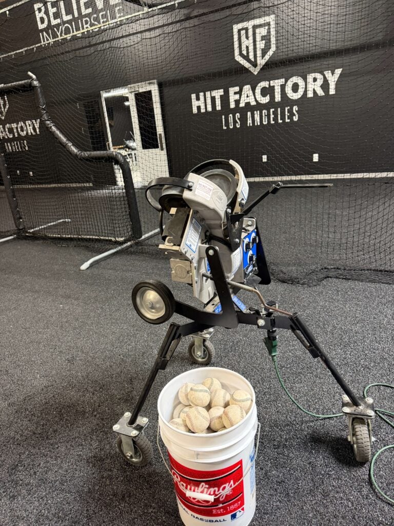 hack attack jr baseball pitching machine w hit factory LA logo in background