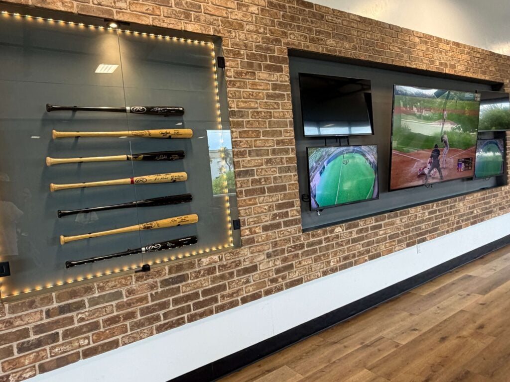display of signed baseball bats and TV at the lounge inside Hit Factory LA