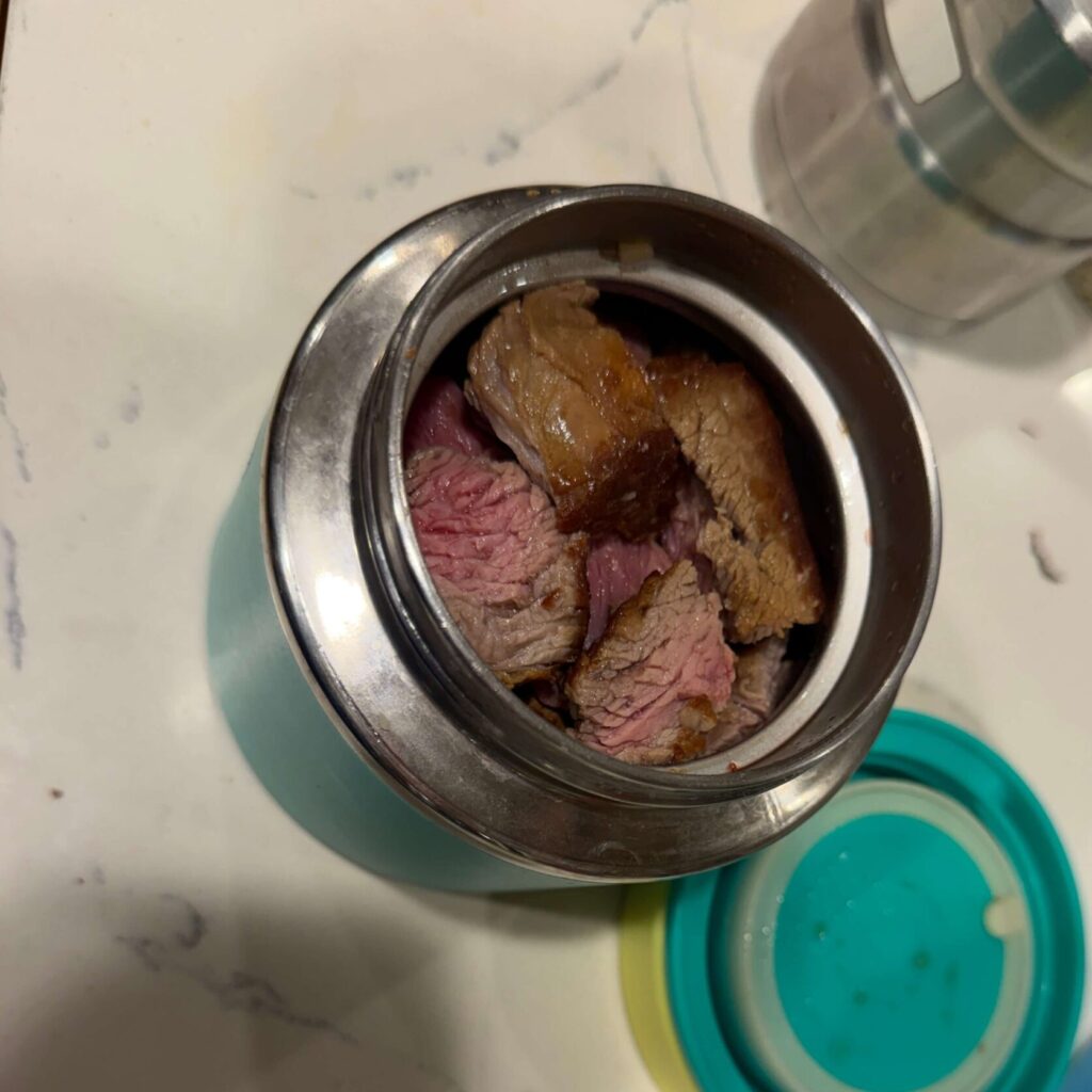 home cooked steak inside thermos container